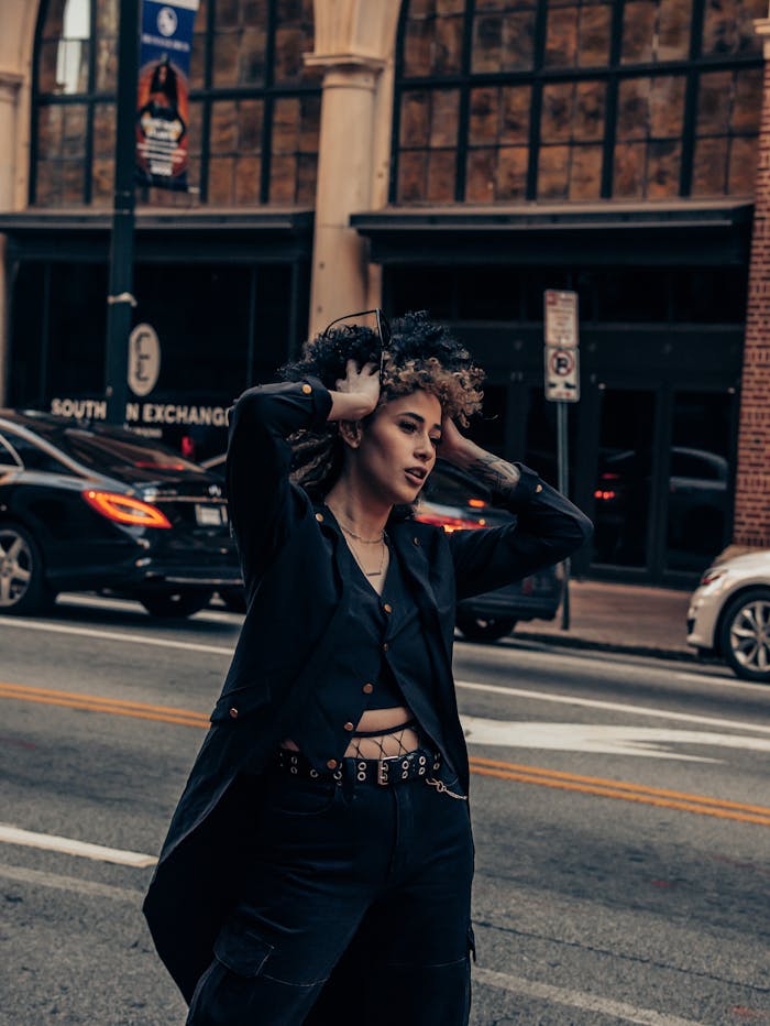 services-02 Stylish woman posing confidently in the urban landscape, exuding fashion charisma on a bustling city street.